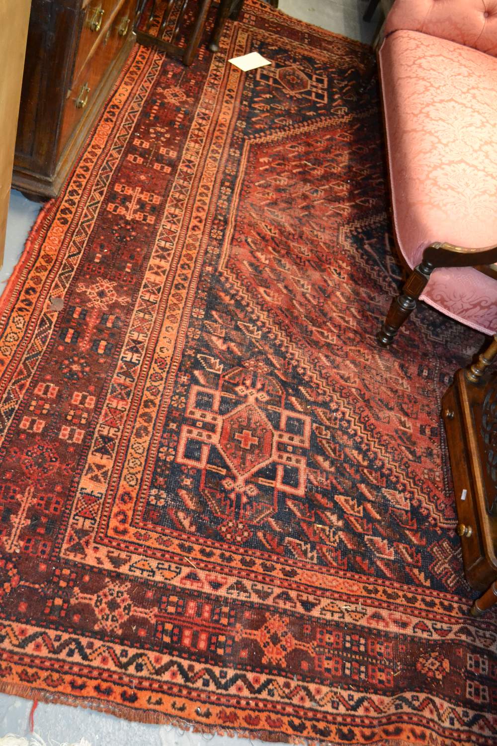 Shiraz carpet with medallion and all-over stylised floral design in shades of red and blue,