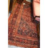 Shiraz carpet with medallion and all-over stylised floral design in shades of red and blue,