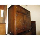 Small reproduction oak dresser with a boarded shelf back above drawers and two cupboard doors