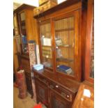 Late Victorian walnut bookcase with a moulded cornice above two glazed doors,