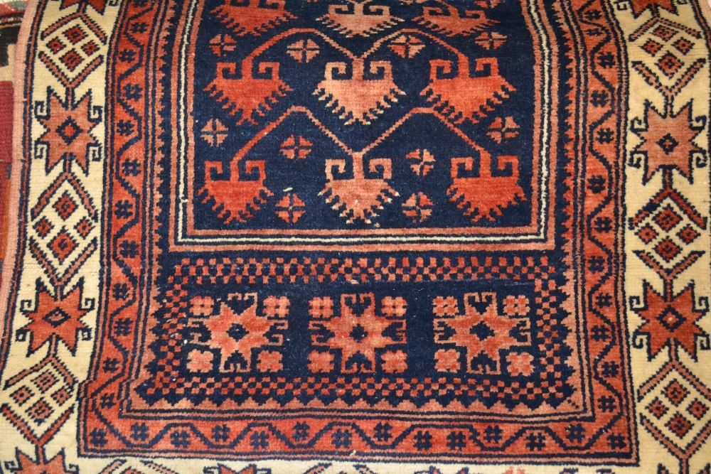 Belouch rug with all-over stylised flower head design on a beige ground with wide borders together - Image 2 of 2