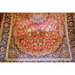 Red ground machine woven Kashan rug, 1.9m x 1.