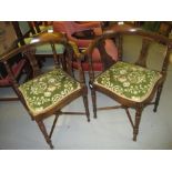 Pair of early 20th Century corner chairs with floral decorated seats on turned supports with