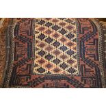 Belouch rug with all-over stylised flower head design on a beige ground with wide borders together