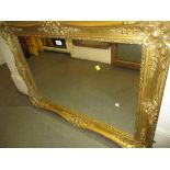 19th Century rectangular swept gilt framed wall mirror,