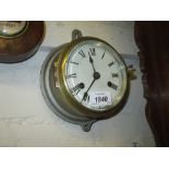 Small silvered metal cased ship's bulk head clock with brass bezel,