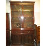 George III mahogany bookcase with a moulded cornice above a pair of astragal glazed doors,