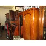 Victorian mahogany wardrobe with a moulded cornice above three doors enclosing hanging space,