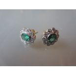 Pair of 18ct yellow gold oval emerald and diamond cluster earrings