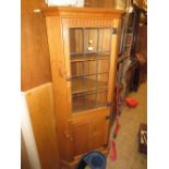 Good quality light oak standing corner cabinet with a leaded glass door
