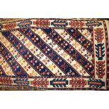 Small Caucasian design rug with diagonal stripe design in cream and blue together with a small