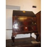 Mahogany bureau circa 1930 with a fall front above three drawers on cabriole claw and ball supports