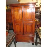 19th Century small colonial exotic hardwood wardrobe having moulded cornice above two carved and