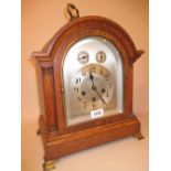 Early 20th Century oak bracket clock, the broken arch case with flanking pilasters,