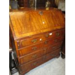 18th Century walnut and crossbanded bureau with a fall front enclosing a fitted interior above four