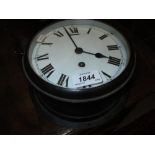 Black Japanned ship's bulk head clock with enamel dial,