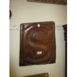 Antique wooden panel carved with letter 'S',