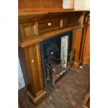 Reproduction Victorian style oak fire surround with a cast iron and tiled insert with fire basket