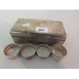 Rectangular London silver cigarette box together with four various silver napkin rings