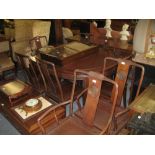 20th Century Chinese hardwood dining room suite comprising: extending dining table with two extra