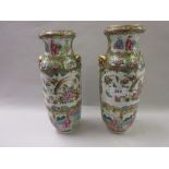 Pair of 19th Century Canton famille rose two handled vases decorated with panels of figures,