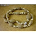 Large vertebrae and carved bone necklace,