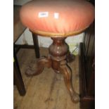 Victorian circular carved walnut adjustable piano stool on tripod support together with a similar