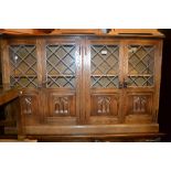 Reproduction oak dwarf four door bookcase with leaded and Gothic arch panel doors
