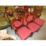 Set of six Victorian mahogany balloon back dining chairs with red drop-in seats on baluster turned