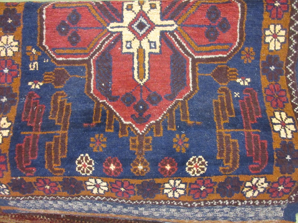 Belouch rug with a single medallion design on a blue ground with Kelim fringes