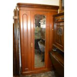 Victorian mahogany wardrobe with a moulded cornice above centre mirrored door flanked by two panels