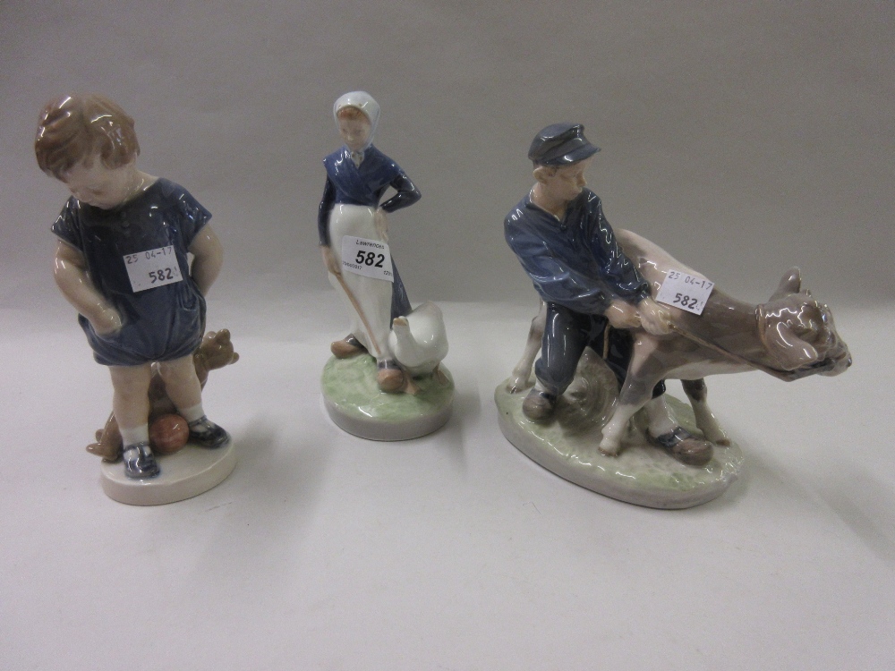 Royal Copenhagen figure of a goose girl and another of a boy with a calf together with another of a