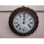 Circular carved oak rope pattern wall clock, the enamel dial with Roman numerals,