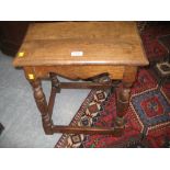 Good quality reproduction oak joint stool with a moulded plank top above a carved frieze and