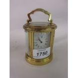 20th Century miniature oval gilt brass cased carriage clock with a single train movement,