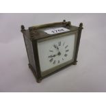 Small brass cased carriage clock with enamel dial and Roman numerals (crack to dial)