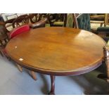 Victorian mahogany oval centre table on a carved column support with tripod base