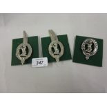 Three various Seaforth Highlanders cap badges