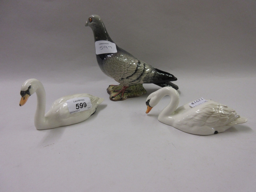 Pair of Beswick figures of swans together with a Beswick figure of a pigeon