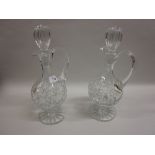 Pair of cut glass pedestal decanters with stoppers