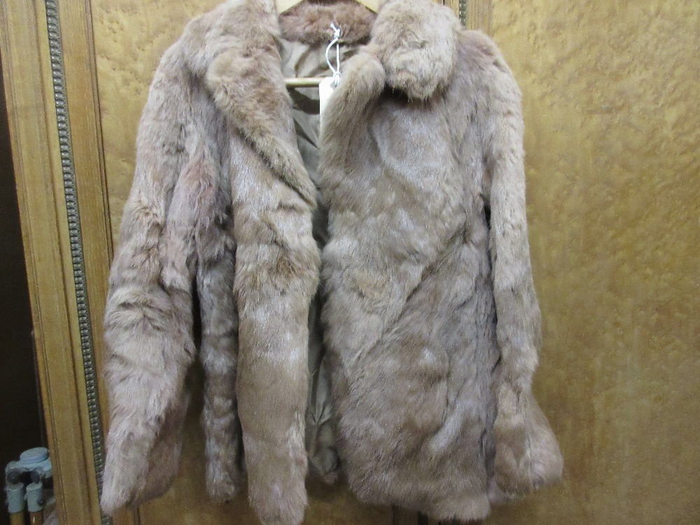 Ladies pale brown fur jacket together with a goat skin rug
