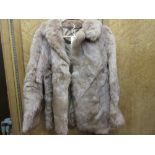 Ladies pale brown fur jacket together with a goat skin rug