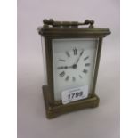 Small brass cased carriage clock with enamel dial and Roman numerals