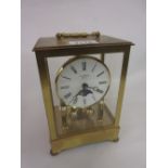 Brass cased four glass three hundred day clock by E.A. Coombs, London with a moon phase dial, 7.