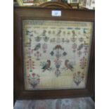 Early 19th Century pictorial needlework sampler with two parrots surrounded by various animals and