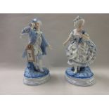 Pair of French blue and white porcelain figures of a lady and gentleman (one a/f)