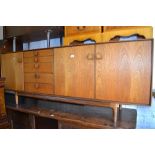 Mid 20th Century Danish teak sideboard with five drawers and three cupboard doors,