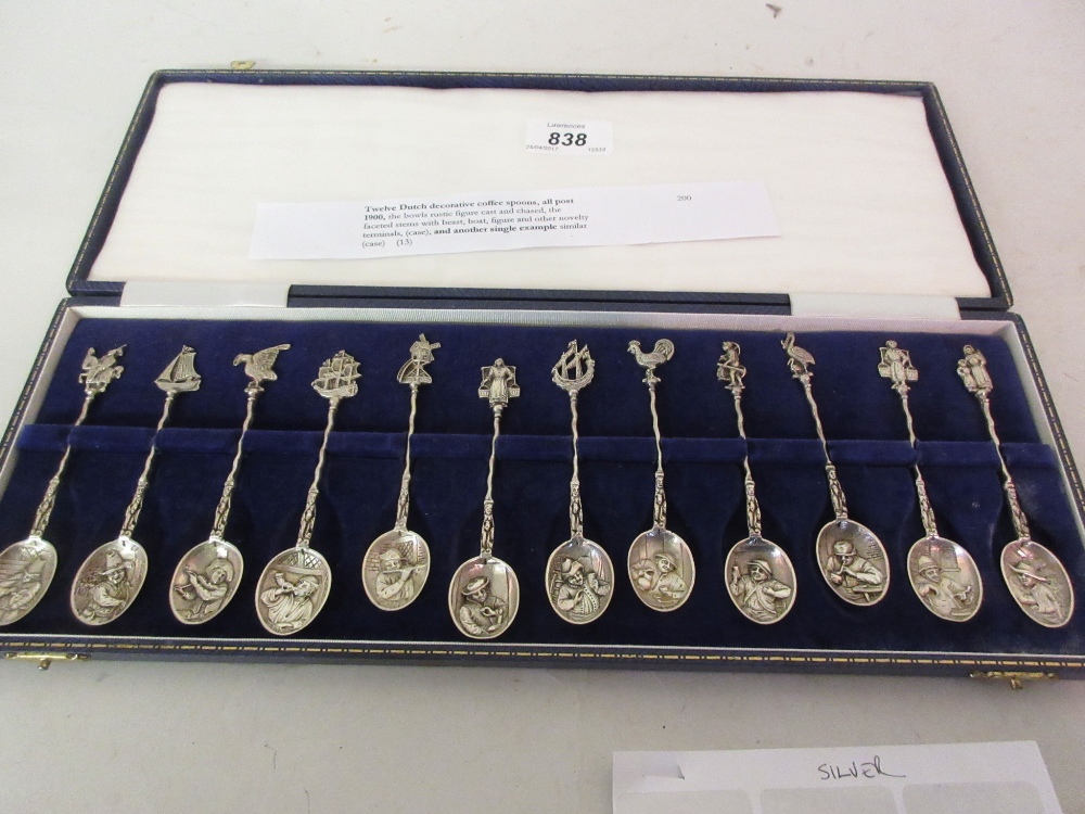 Cased set of twelve Dutch silver spoons with decorative bowls and cast finials