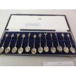 Cased set of twelve Dutch silver spoons with decorative bowls and cast finials