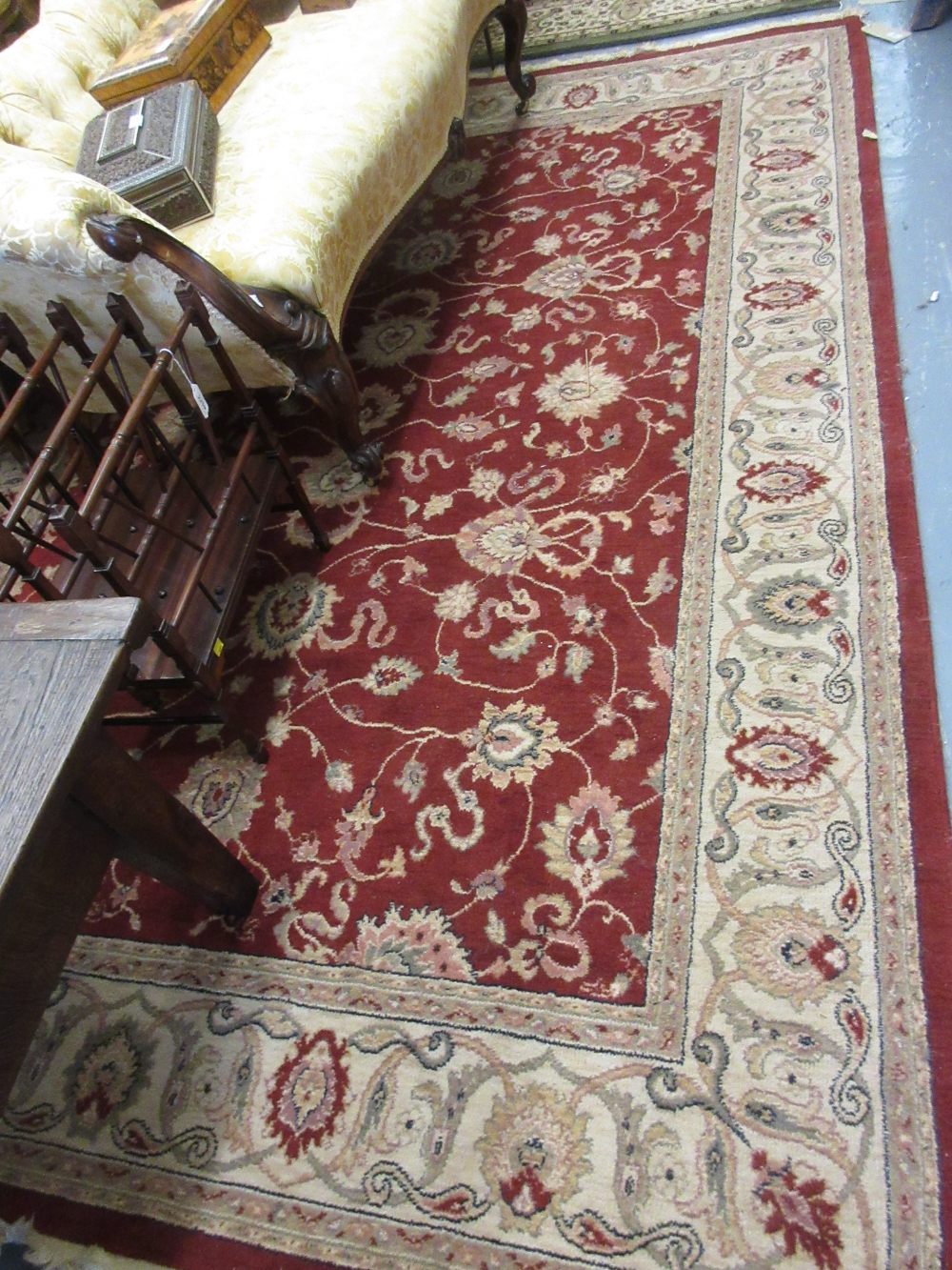 Machine woven Persian design carpet with medallion and floral design on a red ground,